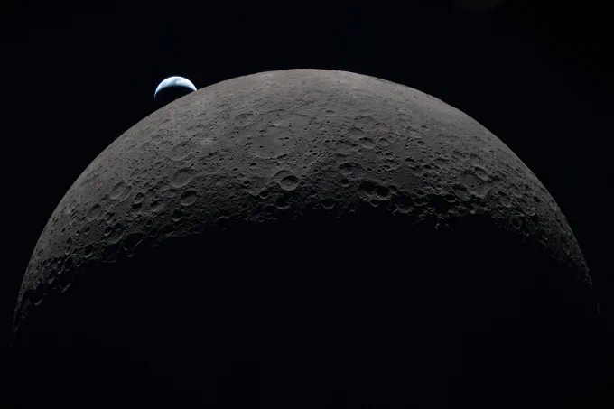 A crescent Earth setting behind a hemisphere of the Moon. Credit: NASA
